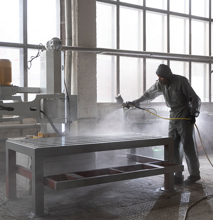 man spraying powder paint from gun full shota